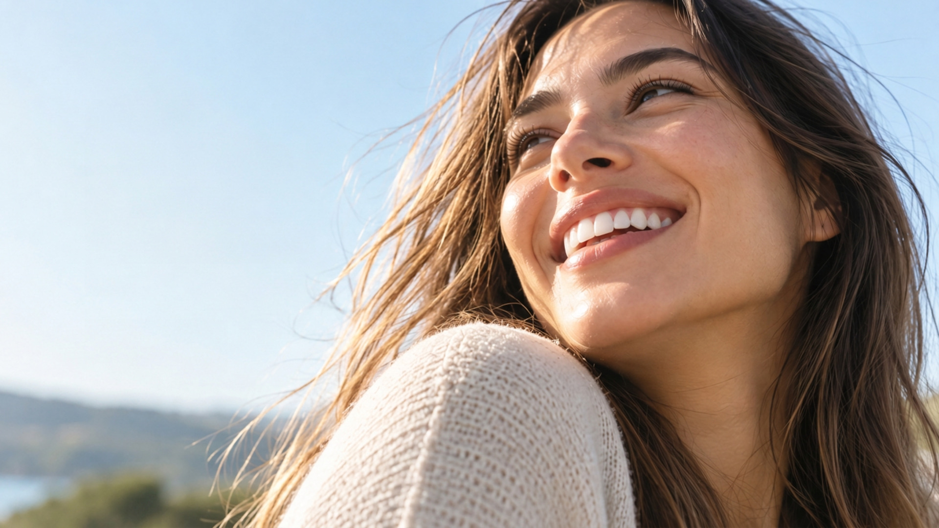 Woman smiling outdoors in the sunshine